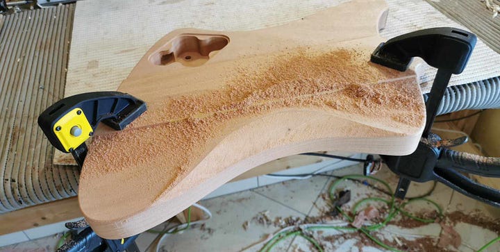 Pictures of the full guitar before and after the neck is glued on. And the detail of 'gutaway'.