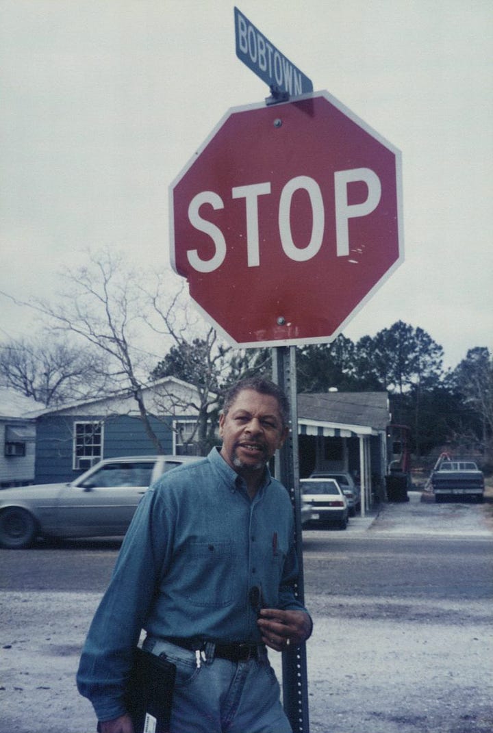 Left: Bobtown Circle stop sign, 1987. Right: Roland Charles stands next to a stop sign in Bobtown. Roland Charles Collection © Tom and Ethel Bradley Center. 