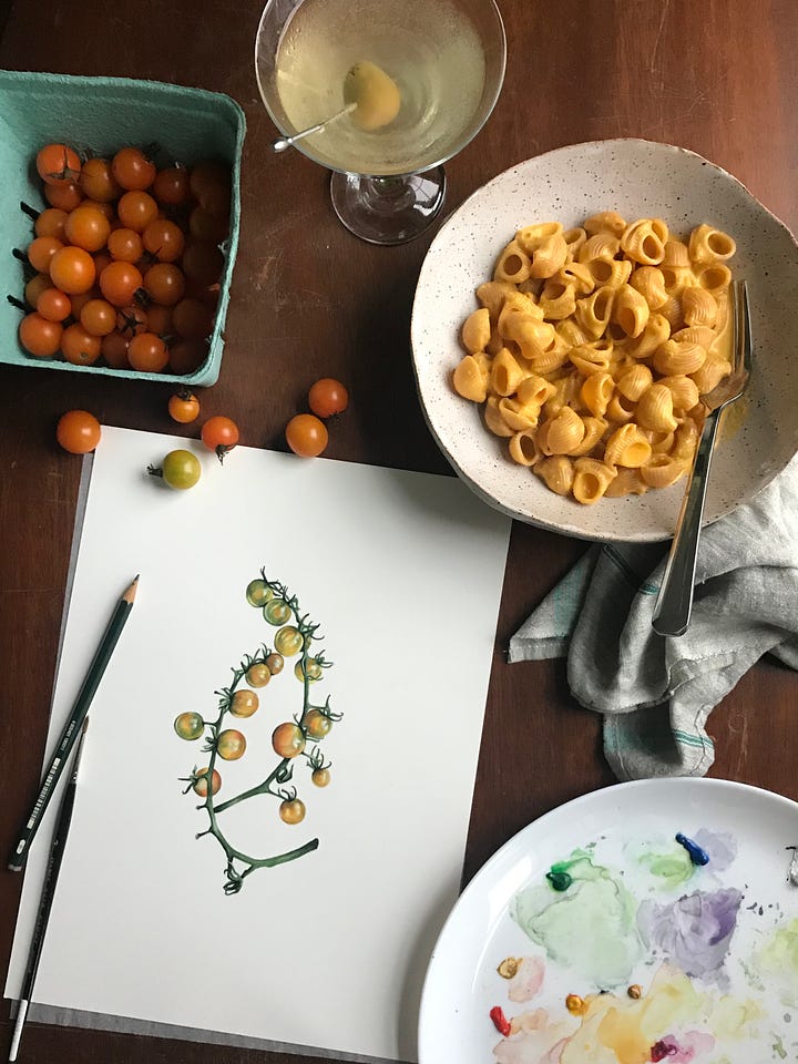 Image on the left is of a large red tomato and microgreens in a bowl, sitting next to a painting of some red costoluto tomatoes. A little box of paints is in the top right corner and a couple paintbrushes lay across the painting. The image on the right is of a painting of sungold tomatoes, sitting next to a bowl of pasta with sungold tomato butter sauce across it, and a bunch of little fresh sungold tomatoes scattered across the desk surface. 