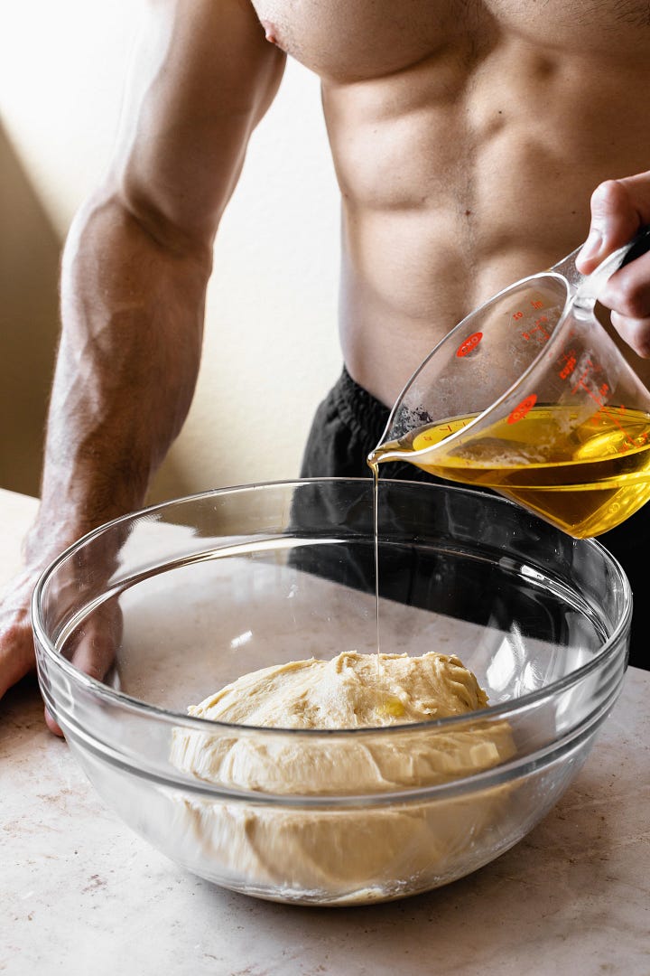 Shirtless man showing steps to make vegan olive oil brioche dough