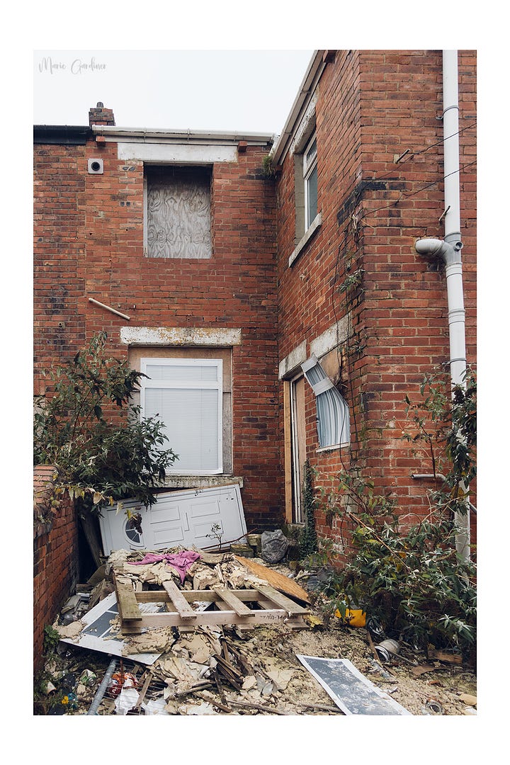 Empty property which has been burnt out and fly tipped