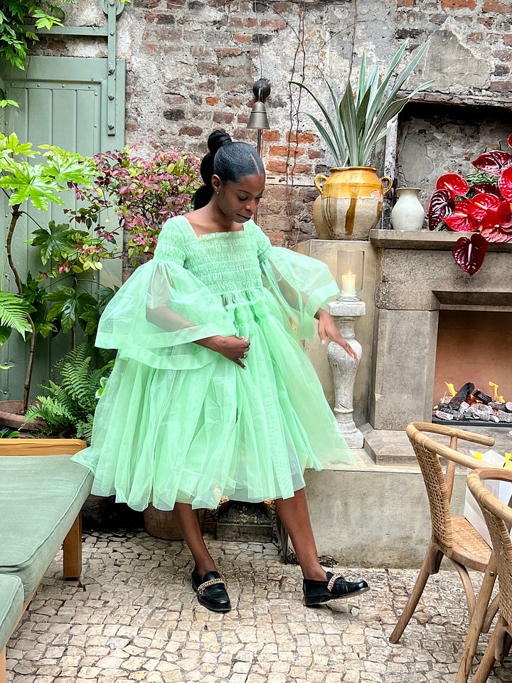 Otegha wearing a mint green tulle dress. Rihanna wearing a version of the same dress.
