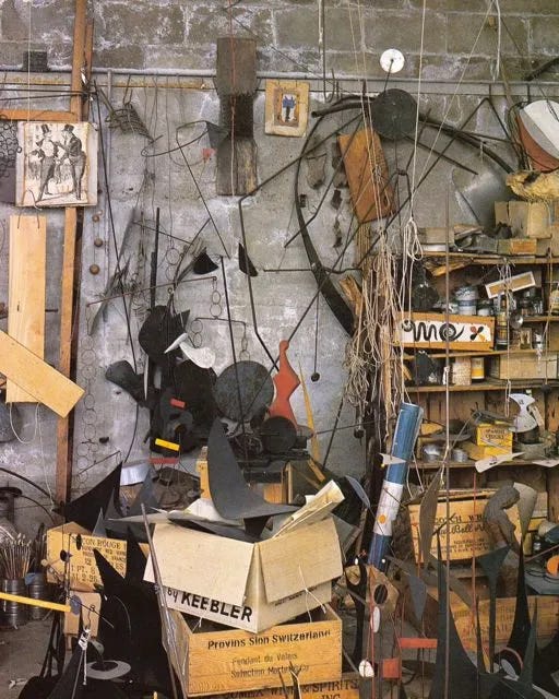 Alexander Calder in his studio in Roxbury, CT. At right, Constellation with Sundial, a sculpture from 1943.