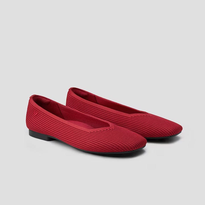 A long sleeve long dress with blocks of color and a pair of red flat shoes
