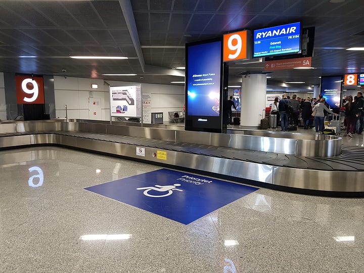 Airport luggage belt wheelchair sign designated area and chairs to use for travelers who cannot walk long distances