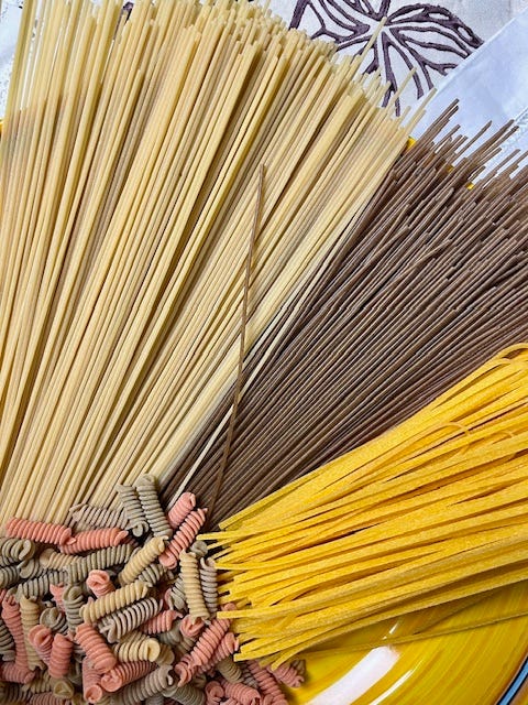 Photo 1 - top L to R clockwise: COOKED buckwheat spaghetti, corn linguine, red lentil, chickpea, and pea fusilli, 'normal' durum wheat spaghetti, corn linguini Photo 2 - UNCOOKED 'normal' durum wheat spaghetti, buckwheat spaghetti corn linguini, red lentil, chickpea, and pea fusilli 