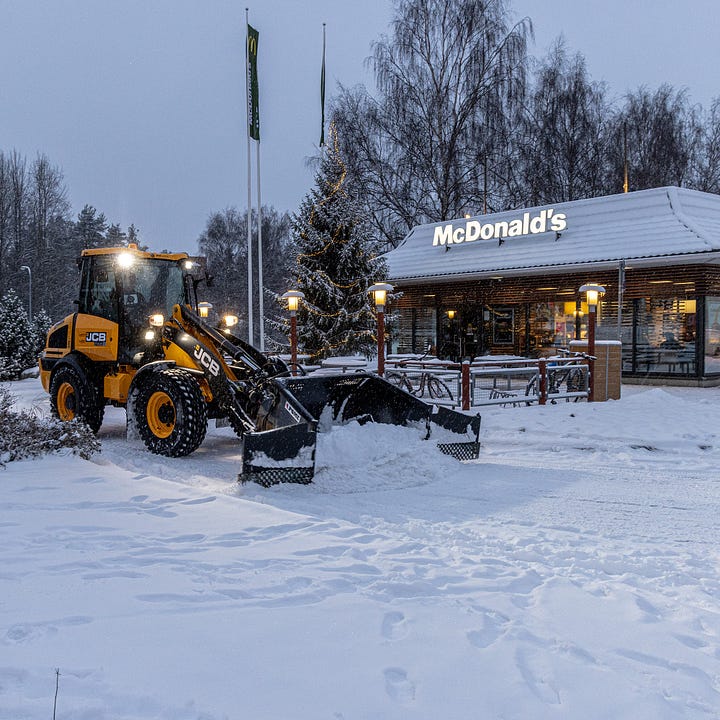 Postcards, the snow-covered drive thru, Happy Meal bird feeder, and poster from the McDonald's in Rovaniemi, Finland