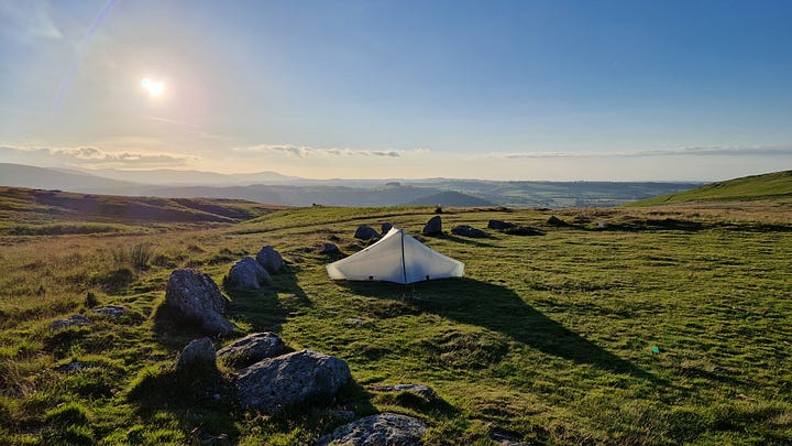 Pictures of a tent in a stone circle. Sunset. Stove with steam.