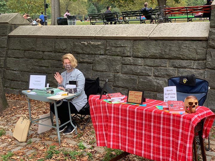 writing poetry and signing books in a park in New York City