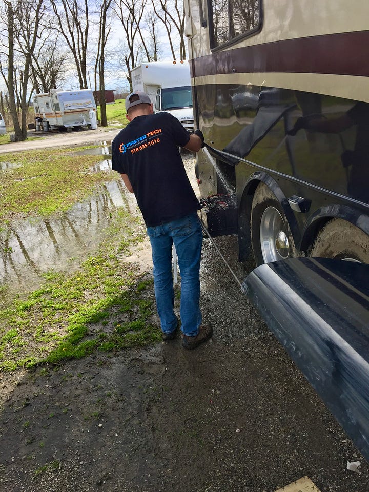 adventure travel Joe the tech working on our coach