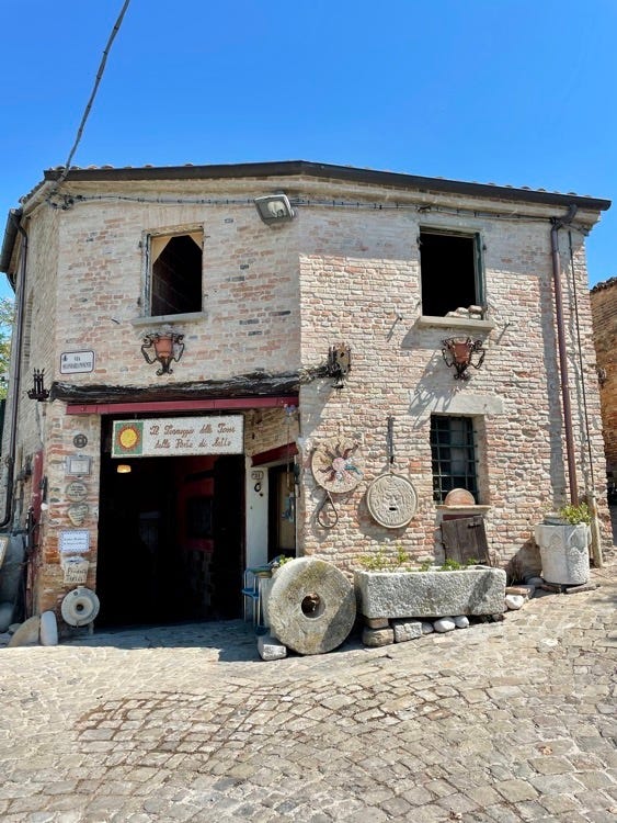 View of the Rocca of Montefiore from below and entrance to the castle. Below, the Rocca Malatestiana of Mondaino and the entrance to the Malatesta Pits.