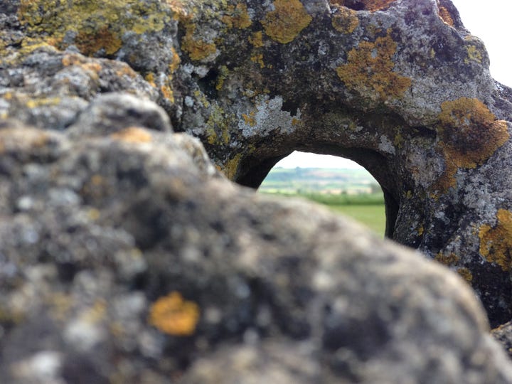 Prehistoric standing stones, one with view through a perfect circle carved through.