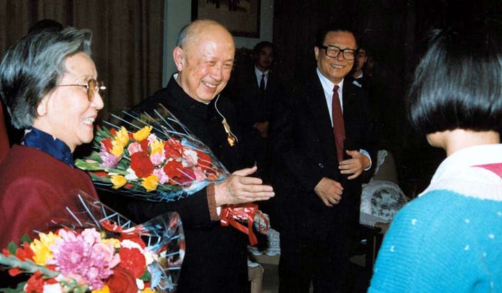 Qian Xuesen with four generations of leaders of the People's Republic of China, in chronological order: Mao Zedong, Deng Xiaoping, Jiang Zemin, and Hu Jintao.