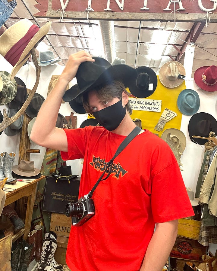 Trying on vintage cowboy hats at the Railyard Artisan Market