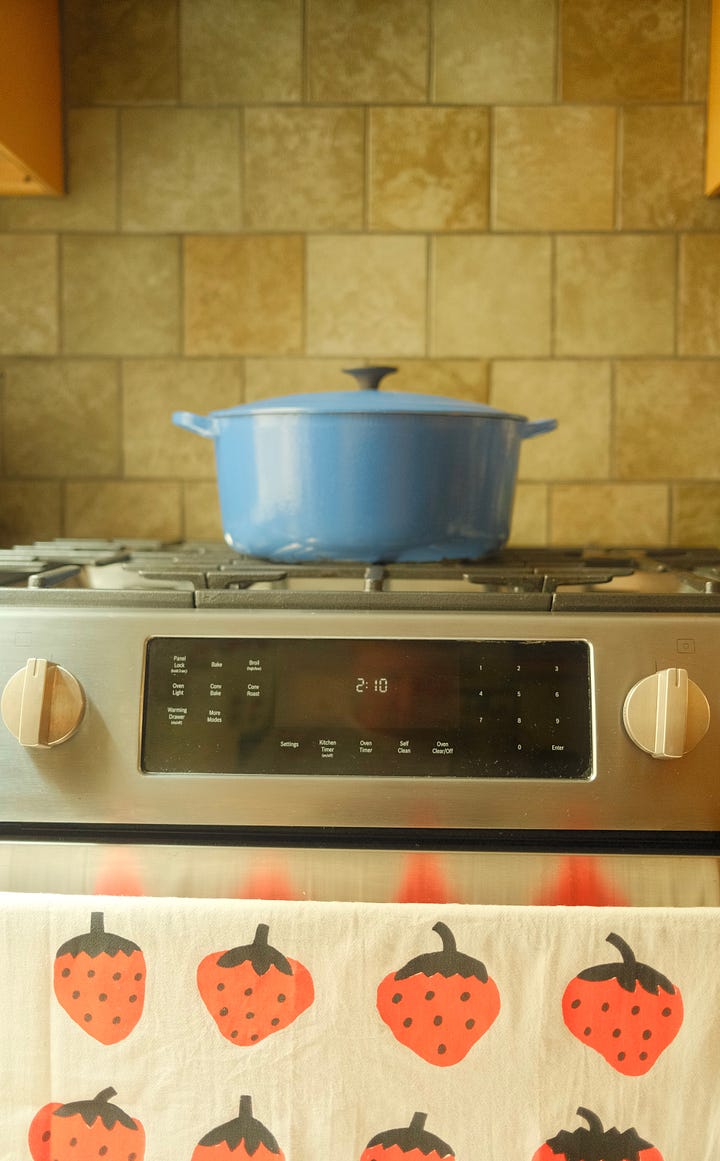 Kitchen stove and jars on a small shelf.