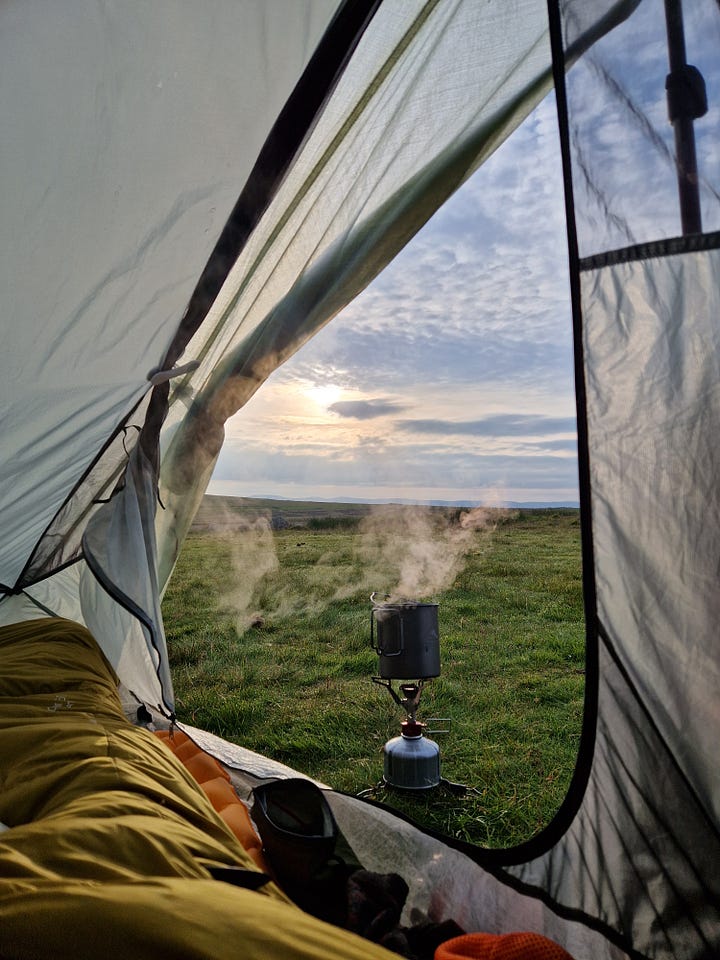 Pictures of a tent in a stone circle. Sunset. Stove with steam.