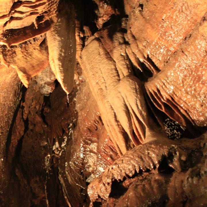 Outside photo of the Niagara Cave Visitor Center and an image from inside the cave