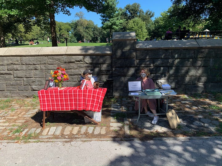 writing poetry and signing books in a park in New York City