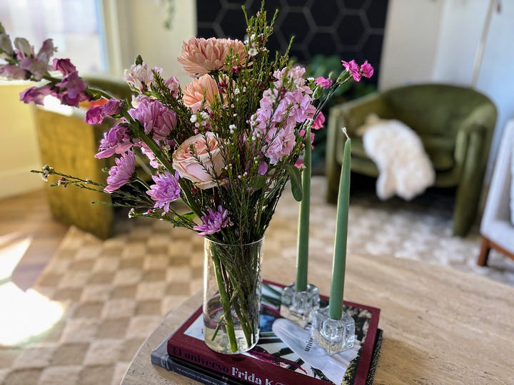 little girl playing outside in the woods and a mother's day flower bouquet displayed in a living room