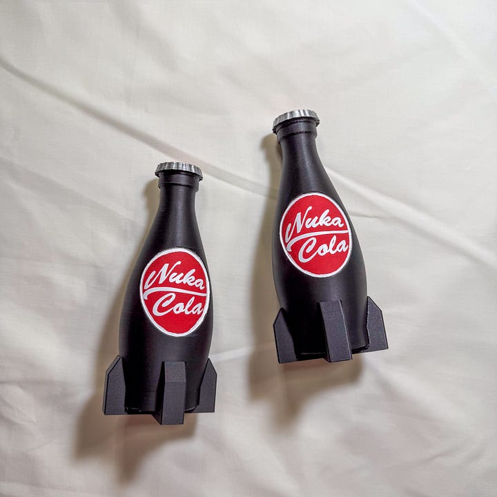 Nuka cola rocket-shaped brown bottles with caps.