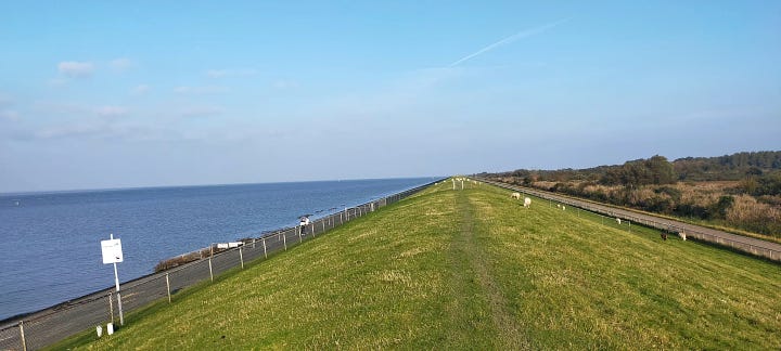 First image depicts a green view of the hiking traill along the Lauwersoog, and the second one shows the route on the map