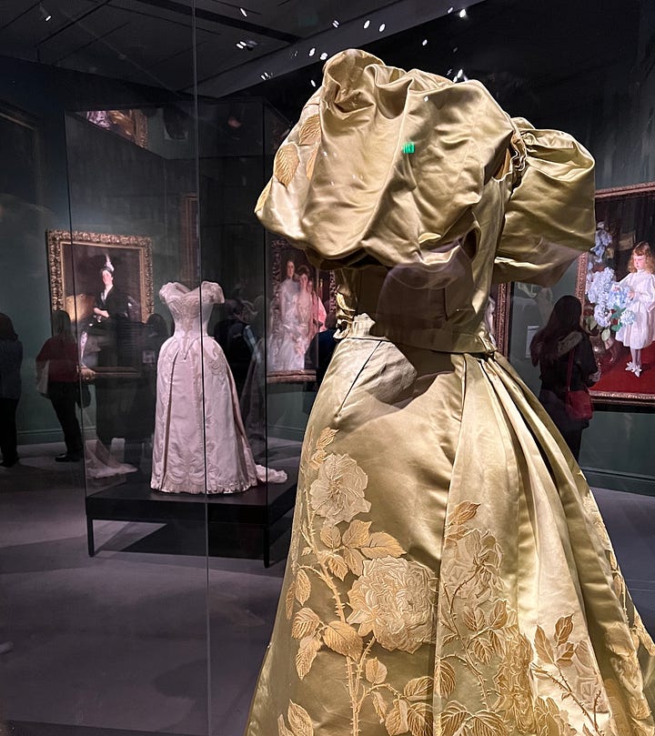 One image of a 19th century woman and her daughter, both in lavish dresses. One image of 19th century dresses in glass cases inside a museum exhibit.