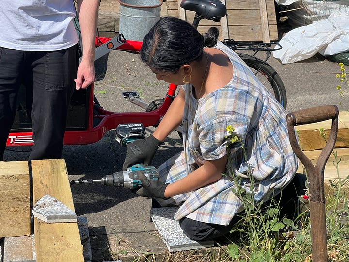 Volunteers using power tools to assemble the pond walls
