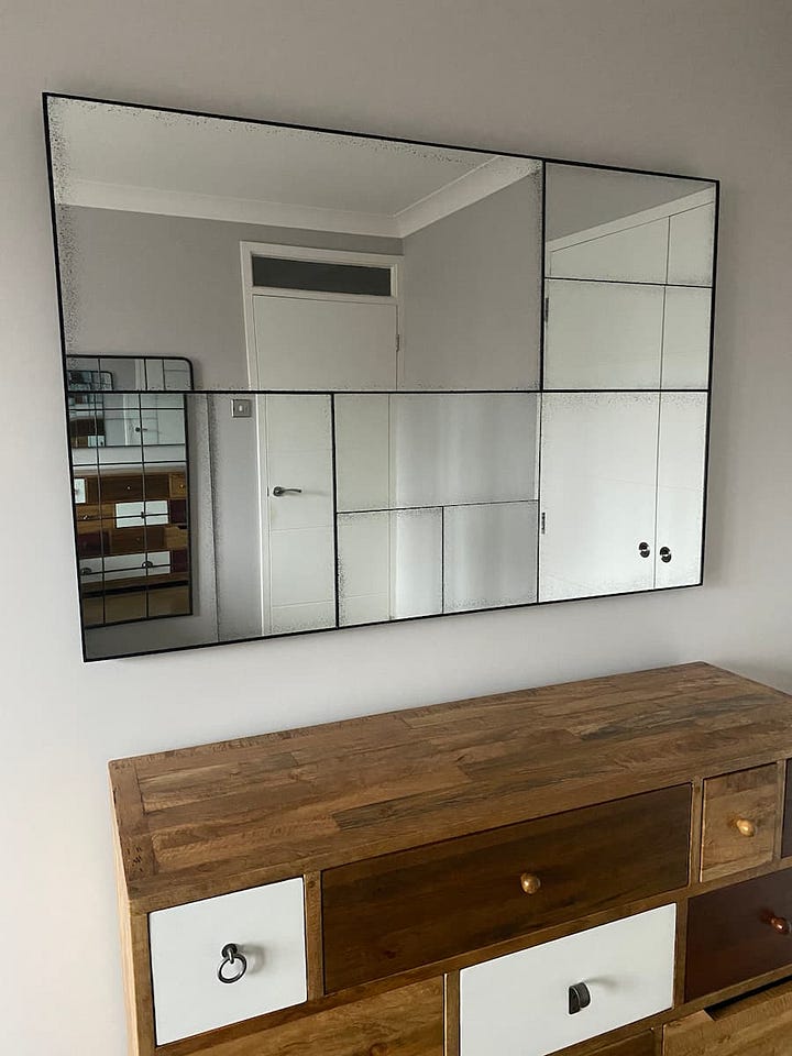 New sleek contemporary mirror compared to the original oversized porthole design mirror