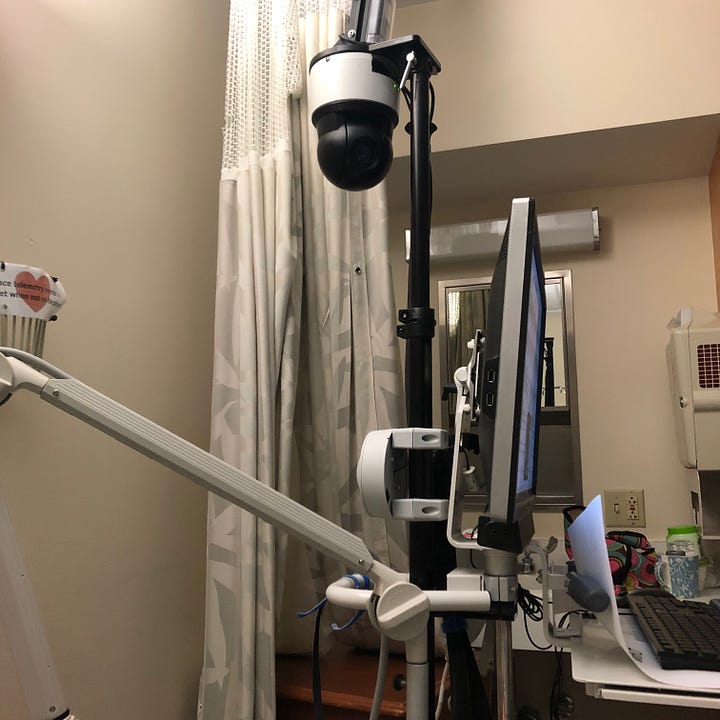 Sample gallery of the EEG stand, topped with rounded black video camera, computer screen with row after row of squiggly lines, the rectangular hanging strobe light, and the rainbow hued collection of wires inside its blue felt carry-pouch.