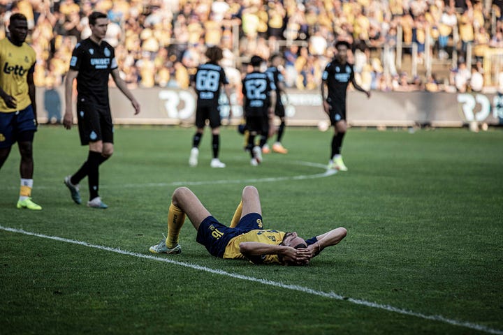 Photos of Royale Union Saint-Gilloise Anthony Moris and Christian Burgess lying on the floor with their hands on their heads after losing on the final day of the 2022/23 season against Club Brugge