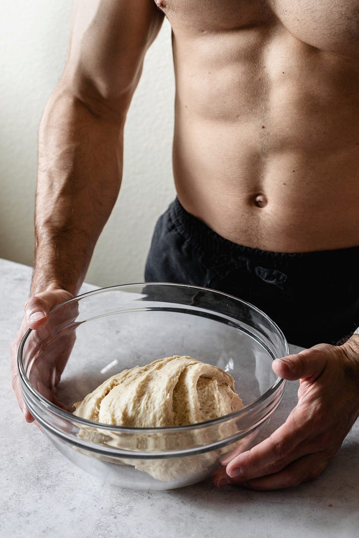 Shirtless man making vegan plant milk bread dough