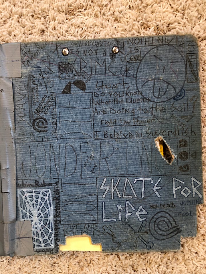 Two cloth-covered three ring binders covered with a highschoolers doodles
