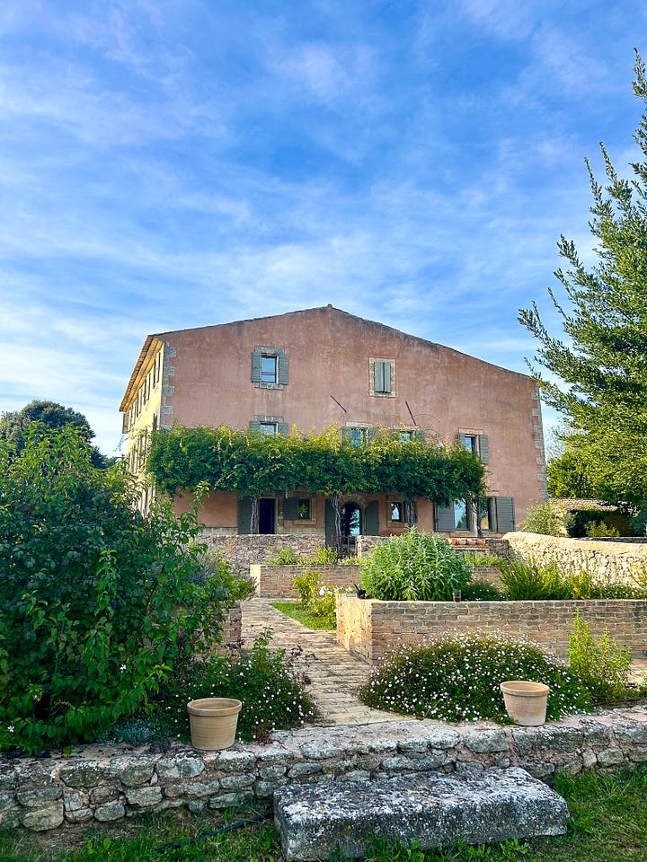 A farmhouse in Provence against a blue sky, a vue into the villa kitchen in Provence, and a window looking at a September sunrise in the south of France