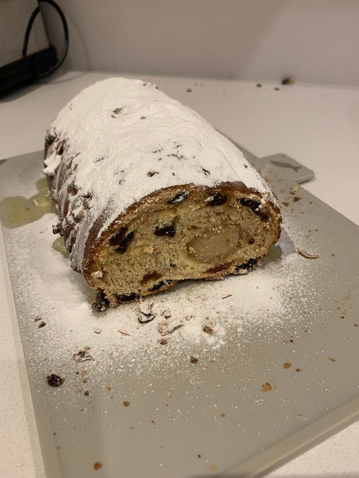left - inside the book; a photo of decorated lebkuchen and the recipe. Right - a photo of a stollen loaf on a grey cutting board.