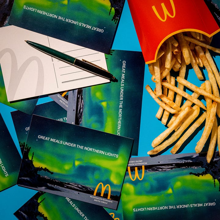 Postcards, the snow-covered drive thru, Happy Meal bird feeder, and poster from the McDonald's in Rovaniemi, Finland