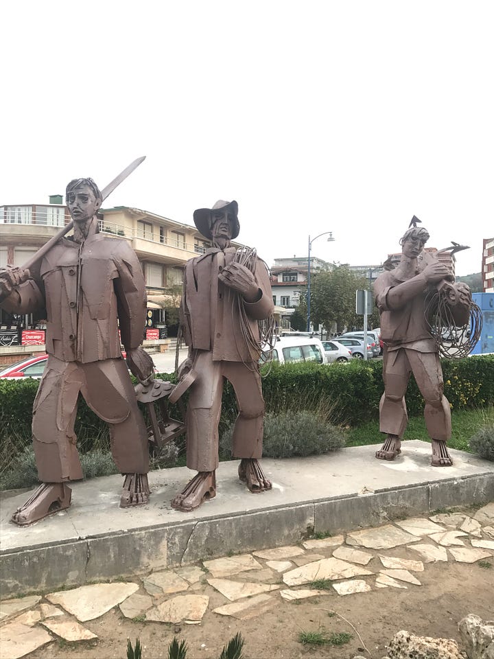 Three images of sculptures dedicated to the mighty anchovy in the port of Santoña, northern Spain.  