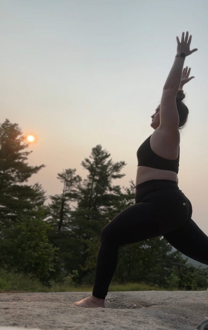 A gallery of images shows a woman standing on a mountain top with the rising sun in the background doing a series of yoga poses.