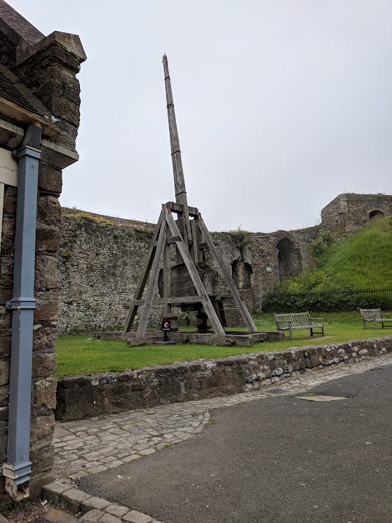 Two images of replica trebuchets at Dover Castle.