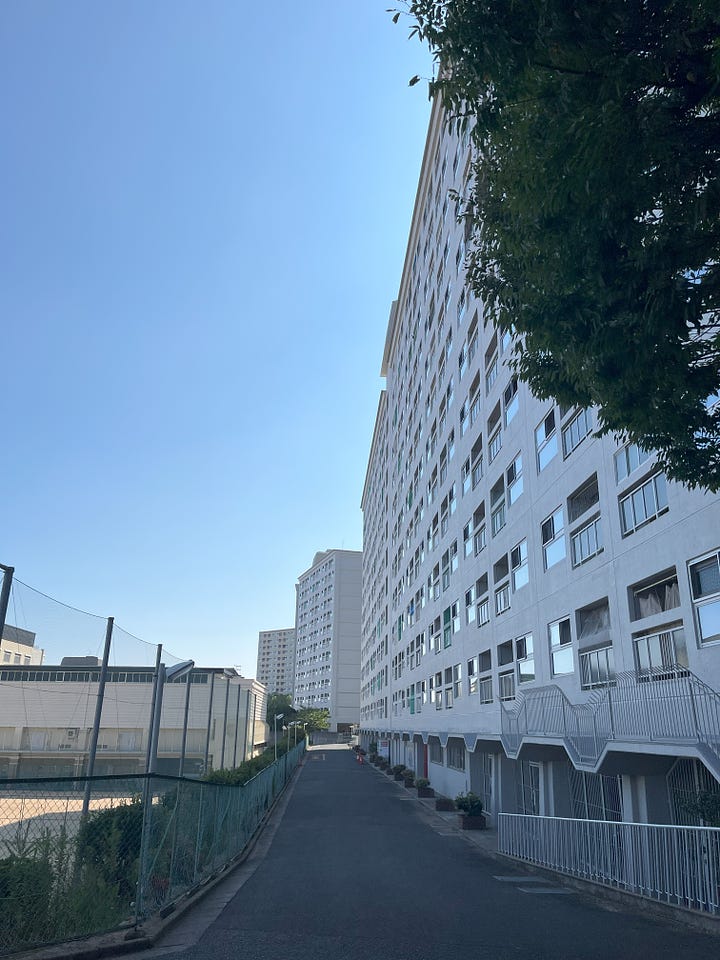 Two pictures of public housing blocks on the outskirts of Kobe. They look like huge walls.