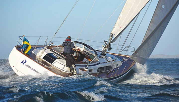 catamaran and monohulled sailing vessels both sailing upwind. 