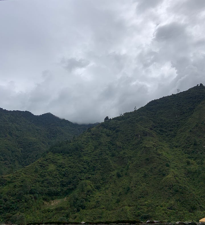 Left to right: Two photos overlooking green landscapes with a cloudy grey sky. The photo was captured near Banos de Agua Santa in Ecuador