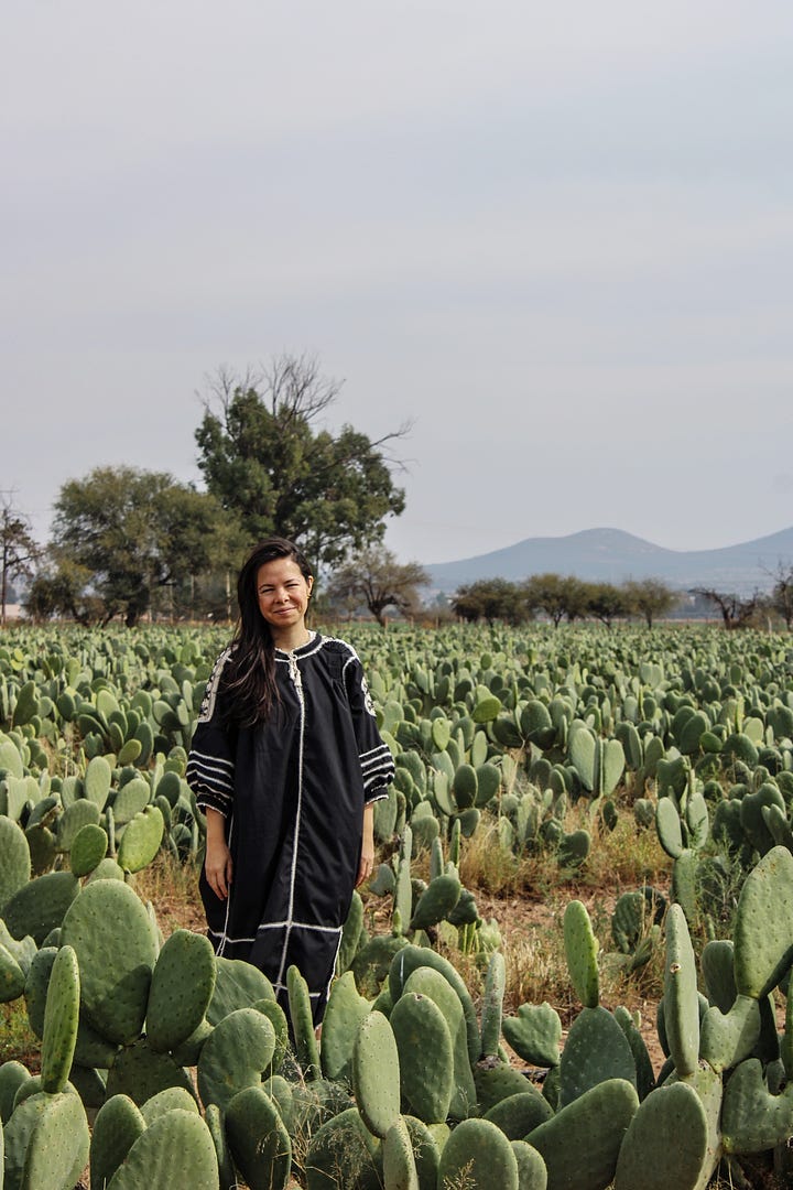 Regina Trillo, Mexican woman, headshot and standing in a field of nopales