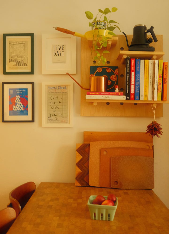 Kitchen with wooden table and shelving on the walls. 