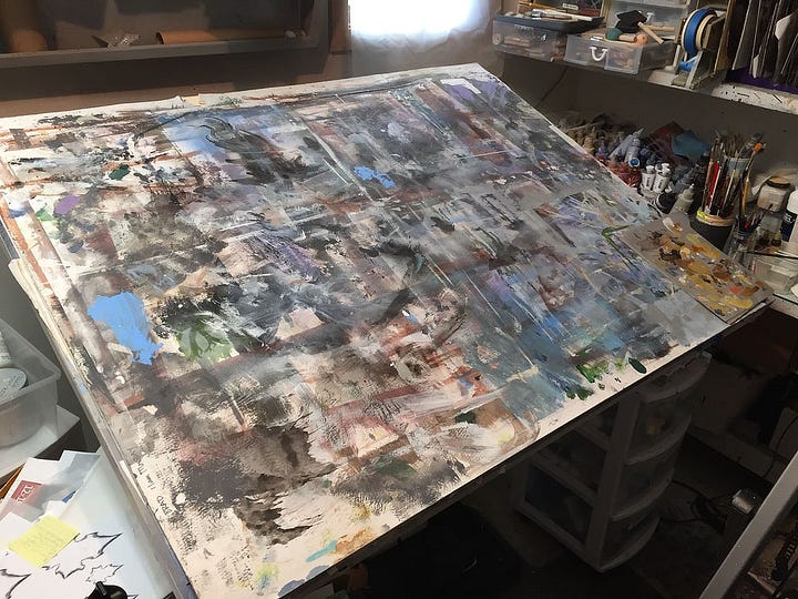 Left: Photo of the protective cover over the drafting table which is filled with chaotic paint markings from overspray and brushmarks. RIGHT: Initial photo of the markings developed into tree on a rocky short with a small figure standing beneath.