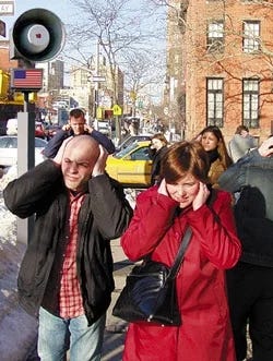 Left A man at a urinal looking at wall-mounted posters of the color-coded national terror-alert level. Right: People covering their ears on the streets of New York City because of noise.