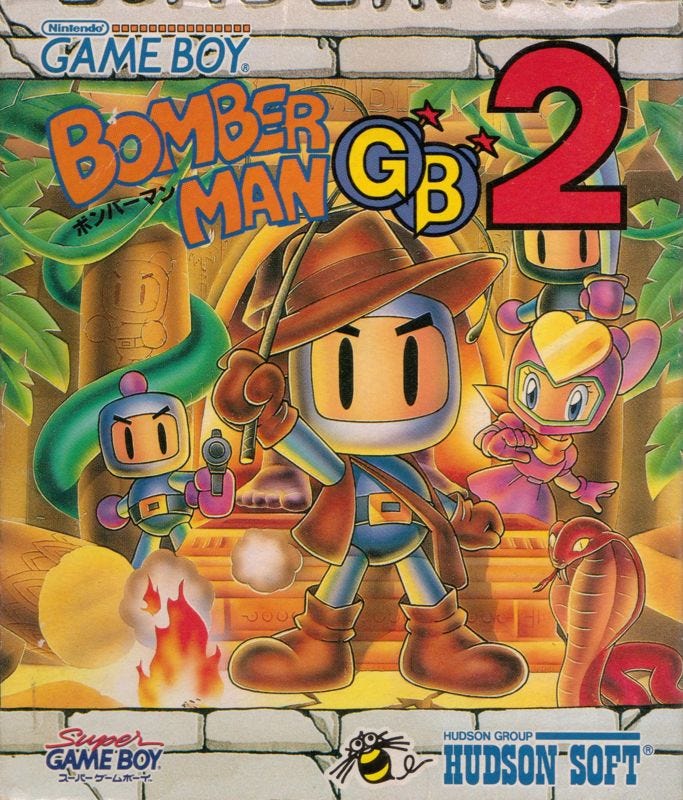 On the left, the North American box art for Bomberman GB, and on the right, the box art for Bomberman GB 2 in Japan. They're actually the same box art, albeit with regional differences in box framing and logo placements, but the names are different due to release histories in the two regions. In both, the central figure is an Indiana Jones-style Bomberman with a whip, and, of course, snakes. It had to be snakes.