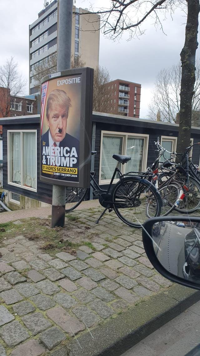 Images depict posters with Donald Trump's face vandalised by a moustache