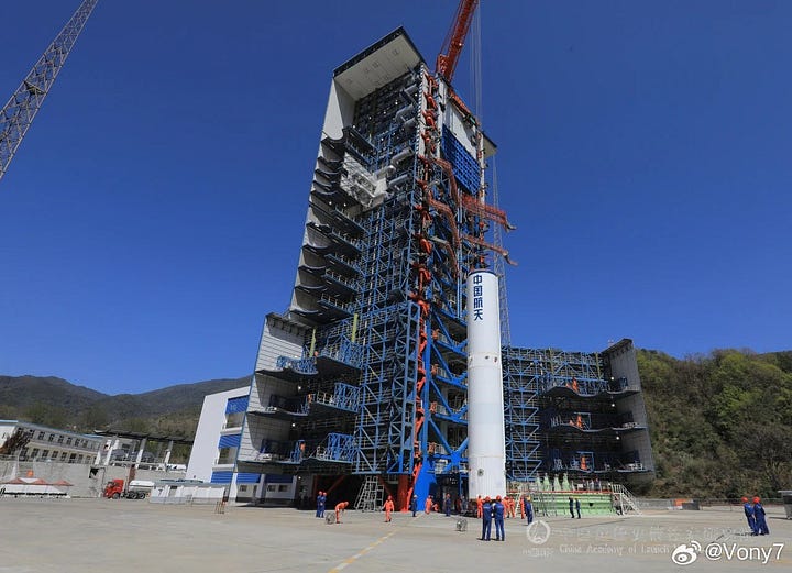 The Long March 3B/E's third-stage heading to the launch pad and its first-stage being placed onto Launch Complex 3.