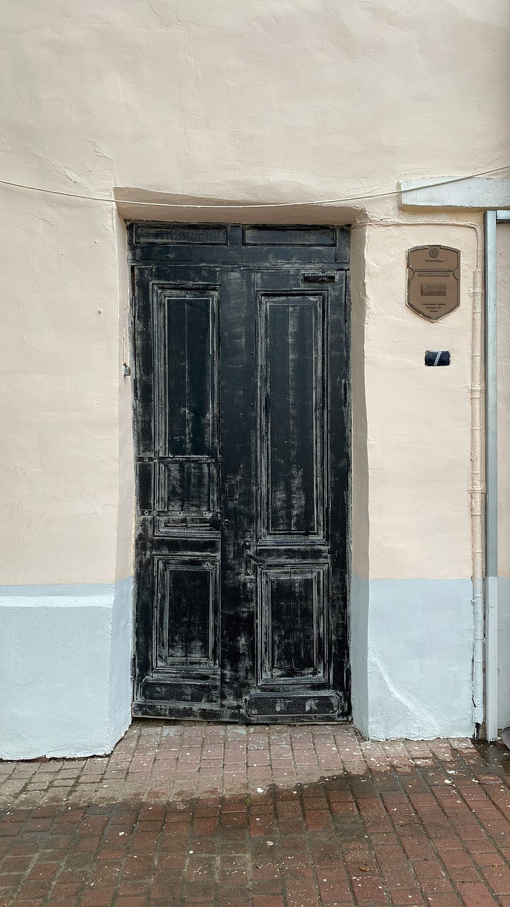 Two pictures of unmarked doors via Unsplash. Neither of these is the one we're talking about.