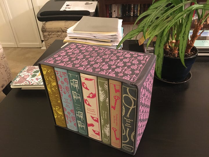 Seven multi colored clothbound books in a printed box. 